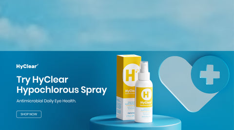 Image of a HyClear hypochlorous spray bottle and box on a blue pedestal. The background features a stylized heart with a cross, and text promoting the product as an antimicrobial spray for daily eye health. Button text reads Shop Now.