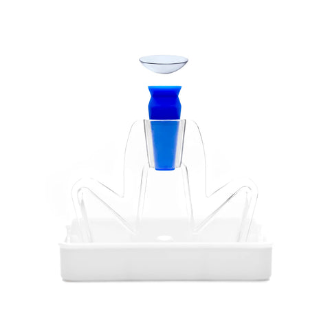 A contact lens is held above a blue and white LensBase Contact Lens Inserter by LensBase, a stylized, person-shaped tool in a tray for clean, safe, and easy contact lens insertion against a white background.