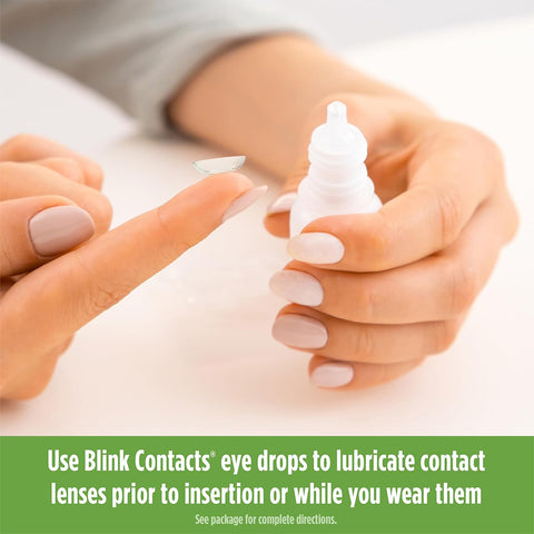 A contact lens wearer balances a lens on their fingertip with Blink Contacts Lubricating Eye Drops (10ml) by Bausch + Lomb beside them, suggesting these drops for keeping lenses comfortable and eyes refreshed.