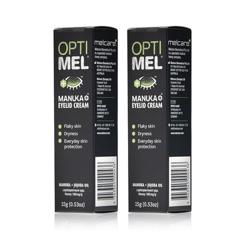 Two tubes of Melcares Optimel Manuka Eyelid Cream (15g each) are shown with green and white text emphasizing benefits like relief for dry, flaky skin and daily protection. Infused with medical-grade Manuka honey and Jojoba Oil for sensitive skin care.