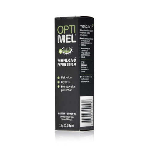 The image shows a black box of Melcares Optimel Manuka Eyelid Cream (15g tube), highlighting its benefits for soothing flaky skin, relieving dryness, and providing daily protection for sensitive skin. Formulated with Manuka honey and Jojoba oil, address and website are clearly visible.