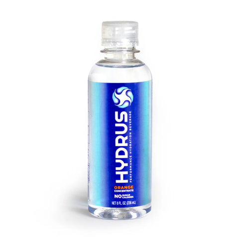 A clear plastic bottle of Hydrus Performance orange concentrate with a blue label features a white HYDRUS logo and Orange Concentrate text. Designed for advanced hydration using Nanosome™ Technology, the calorie-free 8 fl oz (236 mL) bottle supports eye health and whole-body hydration.