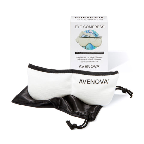 A white Avenova Microwavable Heat Eye Compress Mask rests on a black pouch in front of its box, which displays an image of the compress and info about Avenova’s relief for blepharitis and eye diseases.