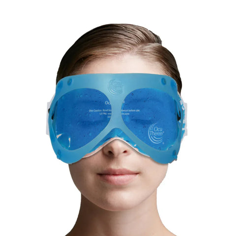 With hair pulled back, a person wears the OcuTherm Heat and Cold Gel Mask Eye Relief from OcuTherm, featuring customizable temperature control. Designed for thermal therapy, this blue mask with small text covers their eyes against a plain white background.