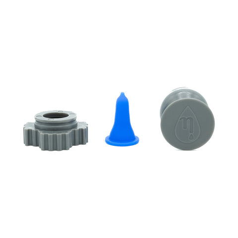 Three items are aligned against a white background: a gray gear-shaped piece, an FDA-listed blue conical Nanodropper Eye Drop Extender Adaptor by Nanodropper, and a gray cylindrical piece with droplet symbol.