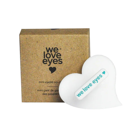 The We Love Eyes Mini Eyelid Scrub Mitt is a heart-shaped antimicrobial tool for eyelid hygiene, featuring the we love eyes logo alongside a brown box with the same design and text.