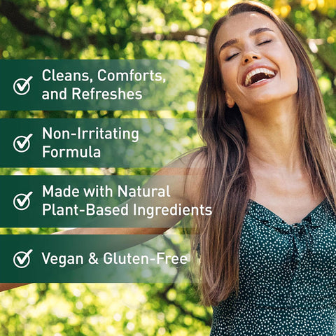 A smiling woman with long hair in a green dress stands outside. Text reads: OCuSOFT Lid Scrub Earth Eyelid Cleanser, Natural Plant Based, with checkmarks: Cleans, Comforts, and Refreshes, Non-Irritating Formula, Made with Plant-Based Ingredients for Natural Eyelid Hygiene, Vegan & Gluten-Free.