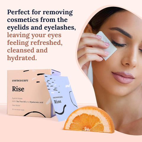 A woman gently cleans her closed eye with a CorneaCare Wipe infused with tea tree oil. A box and sachet of CorneaCare Wipes (30ct) are displayed, stating: Perfect for removing cosmetics from the eyelids and eyelashes. An orange slice is shown at the bottom.