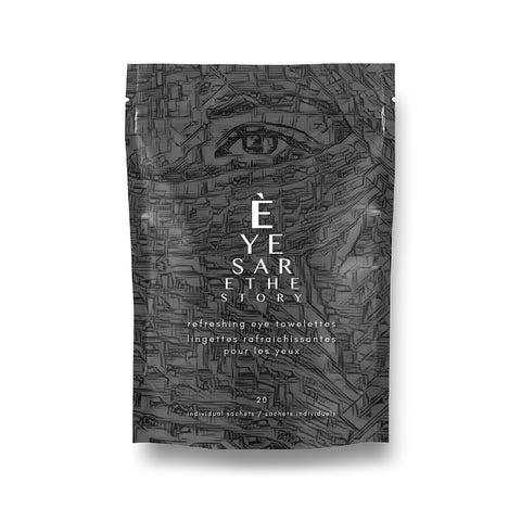 A pack of eye towelettes with a textured black and gray design showcases an eye illustration. Text: Eyes are the Story, Refreshing Towelettes with Aloe. Contains 20 individual sachets for eyelid hygiene by Eyes are the Story.