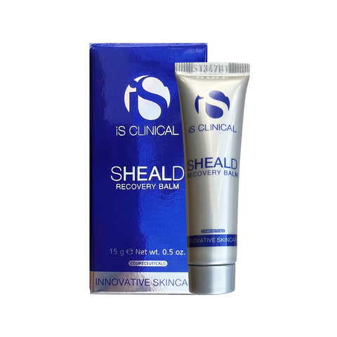 A 15g (0.5 oz) silver tube of iS Clinical Sheald Recovery Balm stands beside its blue box, featuring blue text and offering intense hydration ideal for sensitive skincare needs.