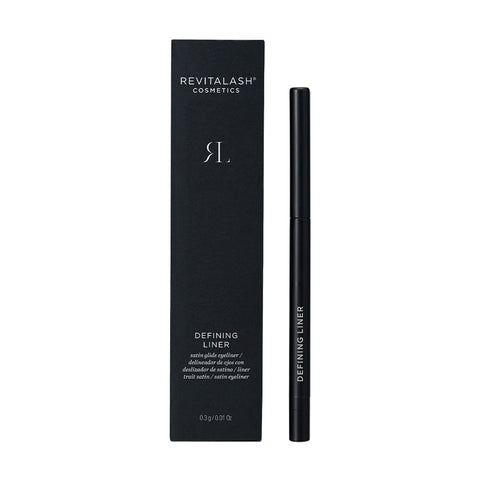 A black RevitaLash Defining Liner Eyeliner stands upright beside its matching box, both with white text and a minimalistic design, showcased on a plain white background for smudge-proof wear.
