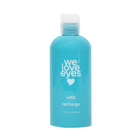 A turquoise 250mL We Love Eyes bottle, featuring a white heart logo and labeled refill and recharge, holds Tea Tree Eyelid Cleanser with a screw-on cap.