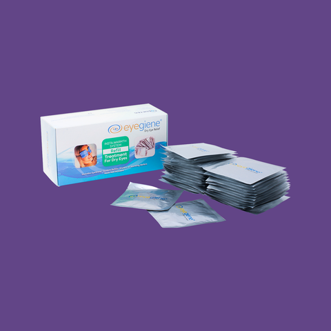 A box labeled Eyegiene with an eye image is set against a purple backdrop. Beside it, foil packets offer dry eye relief and address meibomian gland dysfunction using the EyeGiene Starter Systems Instant Heating technology, which includes 1 mask and 10 pairs of inserts.
