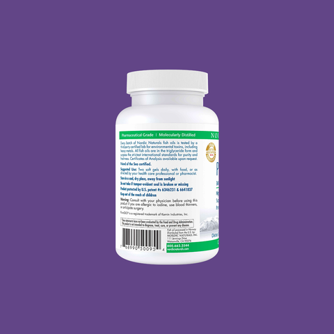 A Nordic Naturals ProDHA Eye supplement bottle stands against a purple background, labeled in green and blue, highlighting details like zeaxanthin. A barcode and certification marks are visible.