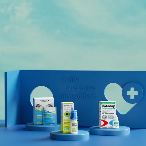 Three eye care products are displayed on a blue backdrop. The packaging includes eye wipes, eye drops, and allergy relief drops. The backdrop features a heart with a cross and the text Daily Eye Care Simplified. The background is a soft blue gradient.