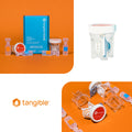 A set of Tangible Boost 2-Pack supplies, designed for maintaining Tangible Hydra-PEG coated lenses, is displayed on an orange background. Three images feature the blue box, a clear lens case with a white cap, and various components meticulously arranged.