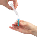 A persons hands are shown, with one hand holding a small inverted container from Visionary Optics Vibrant Vue Saline Lens Rinse and Insertion Fill Solution, 100% preservative-free, dispensing liquid. The other hand holds a blue contact lens suction cup tool for safe handling.