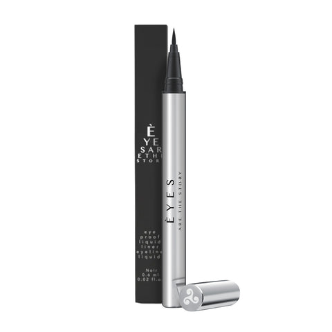 The silver Eyes are the Story Eye Proof Liquid Eyeliner (0.6ml) pen, cap removed, reveals a fine felt tip for precise lining. In the background is a black box with similar branding, suggesting an eye science inspiration.