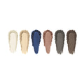 Six makeup swatches featuring white, beige, tan, blue, rose, and taupe shades from the Eyes are the Story Eyeshadow Palette (6 Colors) by Eyes are the Story showcase a textured appearance. These matte eyeshadows deliver an innovative formula with high-pigment hues for striking vibrant looks.