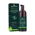 The Noveha Demodex Eyelid Cleanser Foam, Extra Strength Tea Tree Oil Formula (100ml) features dark green packaging with light green text and an eye logo. This hypoallergenic foam is perfect for eyelid cleaning.
