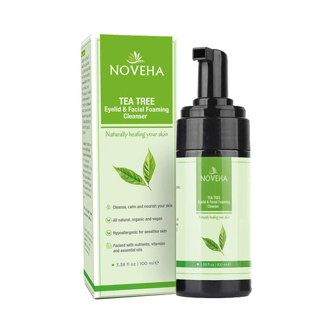 The green and white Noveha Tea Tree Oil Foaming Cleanser for Eyelids (100mL), featuring leaf graphics, is perfect for eye care with its natural, calming, hypoallergenic properties suitable for sensitive skin.