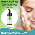 Close-up of someone washing their face with foam. A Noveha Tea Tree Oil Foaming Cleanser for Eyelids (100mL) is shown on the left. Text reads: Ideal for everyday use, cleans deep into pores without drying your skin.