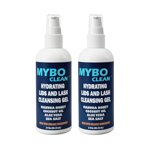 Two 2 fl oz bottles of MyboClean Hydrating Lids and Lash Cleansing Gel feature spray tops and showcase ingredients such as Manuka honey, coconut oil, aloe vera, and sea salt for effective hydrating eyelid cleansing.