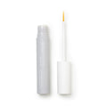 A gray tube of Daily Practice Lash Enhancing Serum, enriched with biomimetic peptides, has a white cap and yellow-tipped brush applicator. Positioned on a white background, its sleek design embodies innovative beauty solutions for fuller, longer, healthier lashes.
