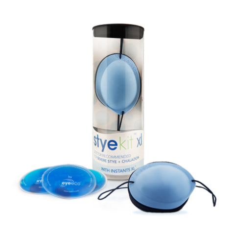 A cylindrical container labeled EyeEco Eyelid Stye Kit (XL - Blue) from PRN contains a blue compress and two eyeeco gel packs for moist heat therapy, alongside a blue eye mask with elastic straps for soothing eye relief.