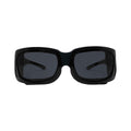 Front view of PRNs EyeEco Small Moisture Release Eyewear in shiny black with gray lenses. Isolated against a white background, these stylish sunglasses come with a microfiber bag for protection, highlighting their sleek design.