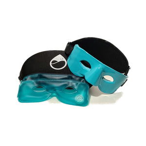 The TearRestore Basic includes two blue gel masks with black elastic bands, designed for comfort and dry eye relief. One mask is slightly behind the other, featuring a logo on its strap. The thermal masks have holes for eyes and nose and are ideal for Meibomian Gland Dysfunction therapy.