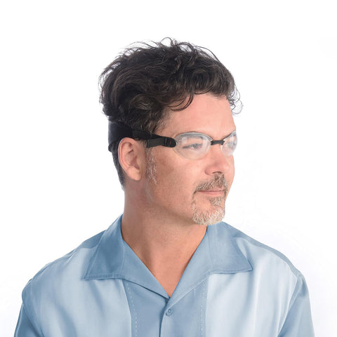 A man with short, dark hair and a thin beard wears the EyeEco Quartz Hydrating Sleep Mask by PRN, featuring clear silicone shields. Hes in a blue collared shirt, maintaining a neutral expression while facing slightly right against a white background.