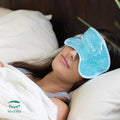 A person lies in bed with a blue PRN MediViz Cooling Eye Mask for Puffy Eyes, Allergies, Sinuses, and Itchy Eyes under a white blanket. Filled with gel beads to soothe puffy eyes and reduce dark circles, the mask features the MediViz logo in the bottom left corner.