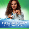 A curly-haired woman smiles while holding a small bottle with a cap against a green background. Text reads, Refresh Tears PF by Abbvie: Double-lockout system keeps preservative-free artificial tears sterile.