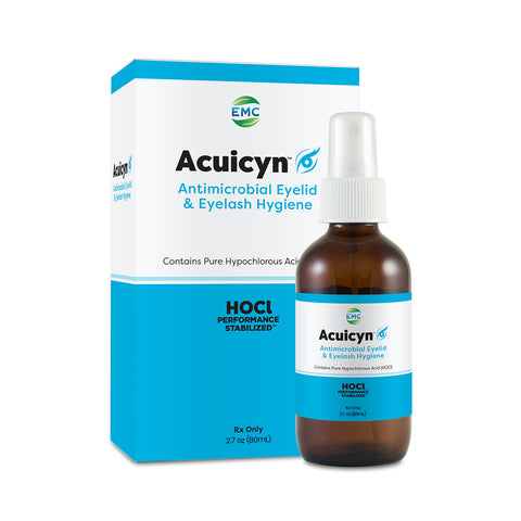 The EMC Acuicyn Antimicrobial Eyelid & Eyelash Hygiene solution aids in blepharitis management. It comes in an amber spray bottle with a white nozzle, featuring a blue and white label, and a branded box. The product leverages hypochlorous acids efficacy.