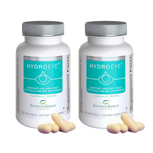 Two white bottles from ScienceBased Health, labeled HydroEye 2-pack Eye Formula Softgels, stand with silver caps, each containing 120 softgels to assist with dry eyes. Three beige capsules in front highlight enhanced tear production.