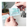 Close-up of a person holding an open packet of MediViz Eyelid Cleansing Wipes by PRN - Physician Recommended Nutriceuticals, ideal for eye health and makeup removal. The blue packet displays a white tear drop design. In the blurred background, theres a plant and silver faucet visible.