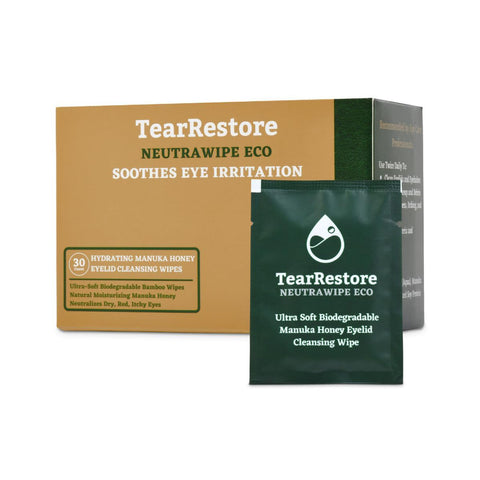 The TearRestore NeutraWipe Eco Manuka Honey Eyelid Wipes, featuring soothing and biodegradable properties in yellow-green packaging, are perfect for sensitive eyes. A single green packet is prominently displayed in front of the box containing 30 ultra-soft wipes.