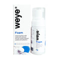 A white bottle of Weye Foam sits beside its packaging. The box and bottle, adorned with black text, describe this cleanser: a 60mL gentle formula with hyaluronic acid, tea tree, chamomile, and calendula for eyelid hygiene and effective cleaning of lashes to help prevent blepharitis.