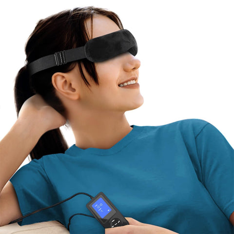 A person in a blue shirt relaxes with the Wizard Research USB Heated Eye Mask, offering soothing heat therapy. They hold a small black device showing 99%. The plain white background ensures focus on their relaxing eye care experience with Wizard Research.