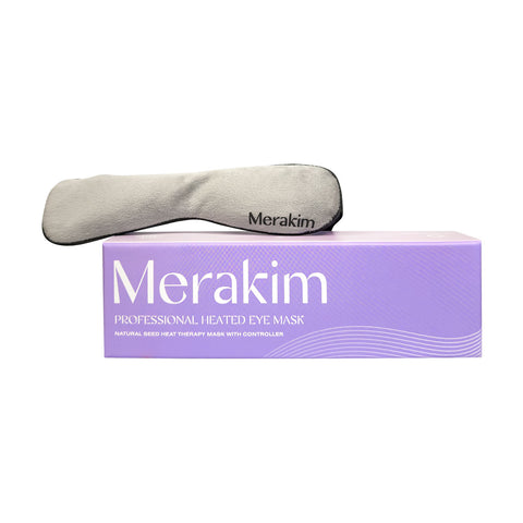 A gray Merakim eye mask sits on its light purple box labeled Merakim Professional USB Heat Eye Mask – Adjustable Warm Compress for Dry Eyes, Fatigue Relief, and Tear Film Support, promoting tear film stability with its easy-to-use controller.