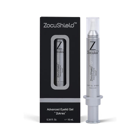 The ZocuShield Gel Eyelid Cleanser by Zocular comes in a sleek, silver cylindrical syringe-like container to soothe dry eyes. It rests next to a black box with a window displaying the okra-infused product. Both feature the prominent Zocular logo and text.