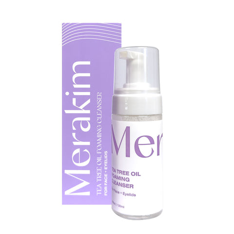 A bottle of Merakim Tea Tree Oil Foam Facial Cleanser (120mL), perfect for soothing dry eye disease and ocular inflammation, is displayed in front of its purple box. The white packaging with purple accents includes a pump dispenser and is labeled for face and eyelids.