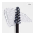 Close-up of a RevitaLash Hi-Def Brow Gel brush on a white surface, coated with the gel and showing smudged texture and transparency. The word CLEAR is printed in the top right corner.