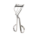 The RevitaLash Signature Eyelash Curler by RevitaLash is a silver carbon steel tool with a polished finish, ergonomic handles, and a curved clamp for effortless curling. It includes silicone lash curler pads and stands upright on a plain white background.
