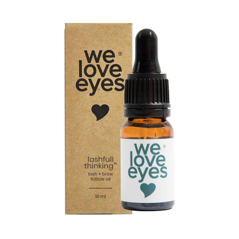 A 10ml amber glass dropper bottle labeled We Love Eyes accompanies a matching box with the heart-branded text: We Love Eyes Lashfull Thinkin Lash + Brow Follicle Oil. Ideal for gently nourishing eyelashes and eyebrows.
