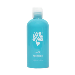 A turquoise 250mL We Love Eyes bottle, featuring a white heart logo and labeled refill and recharge, holds Tea Tree Eyelid Cleanser with a screw-on cap.