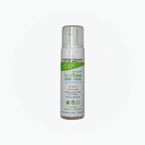 The PRN TranquilEyes Age-Defying 1% Tea Tree Eyelid & Facial Cleanser sits on a white background, highlighting its hydrating and soothing formula with Regu-Age Complex. Its label features green text emphasizing its natural ingredients, ideal for reducing dark circles and puffiness while removing makeup.